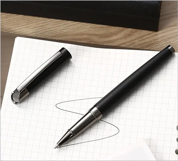 A pen sitting on top of a piece of paper.