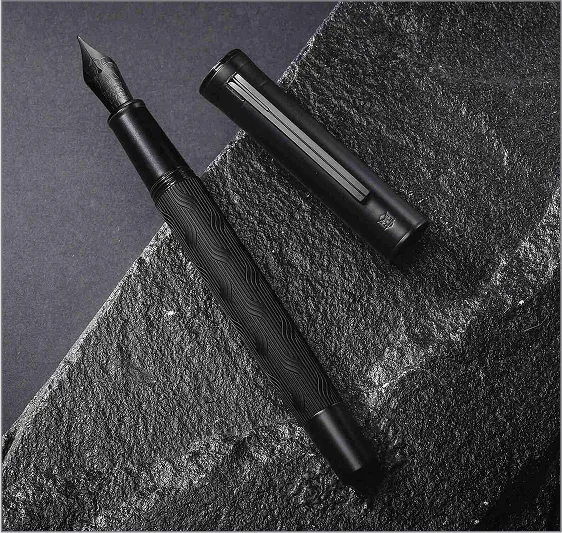 A black and white photo of two pens.